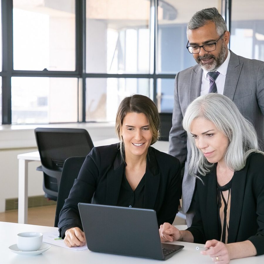 cheerful-business-team-watching-presentation-laptop-sitting-workplace-staring-display-smiling-copy-space-business-meeting-concept_74855-11583