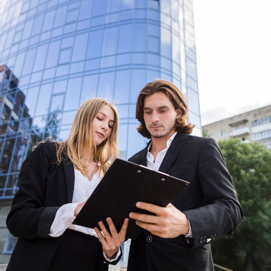 man-woman-looking-clipboard_23-2148230190