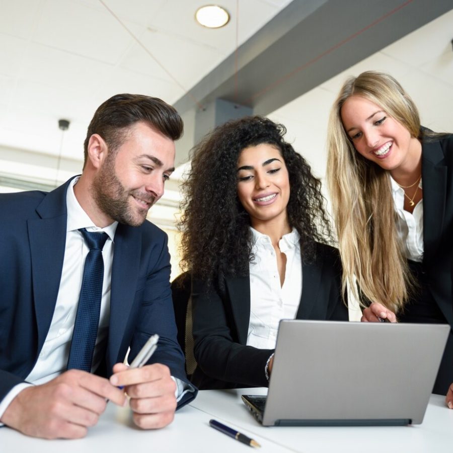 multi-ethnic-group-three-businesspeople-meeting-modern-office-two-women-man-wearing-suit-looking-laptop-computer_1139-967